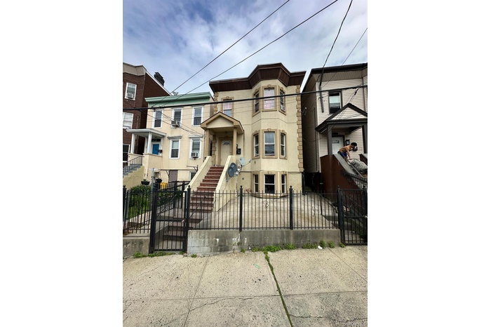 View of front of home featuring a gate and a fenced front yard