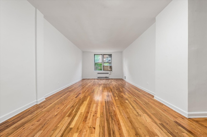 Spare room with light wood-style flooring and cooling unit