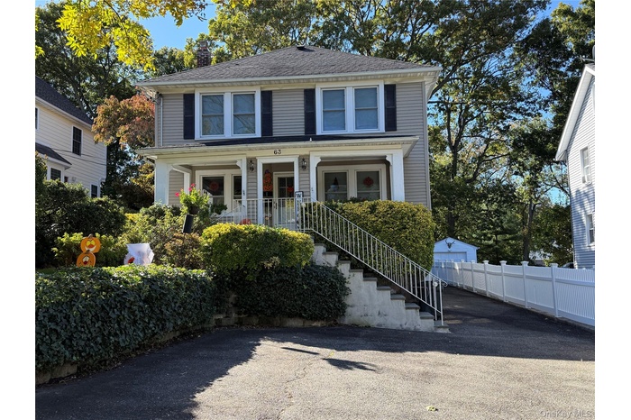 American foursquare style home with stairs, a porch, and a chimney