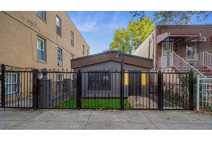 Gate with a fenced front yard and a patio