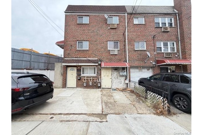 Traditional-style home with brick siding, a garage, and driveway