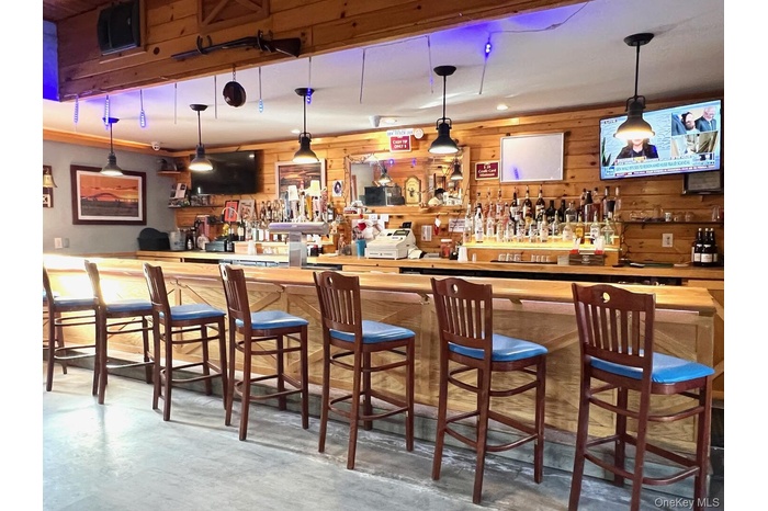 Community bar area with decorative light fixtures and wood counters