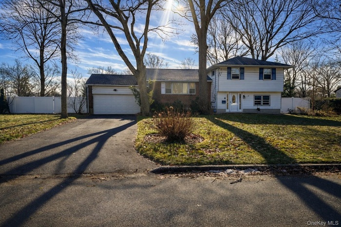 View of front of house with driveway and an attached garage