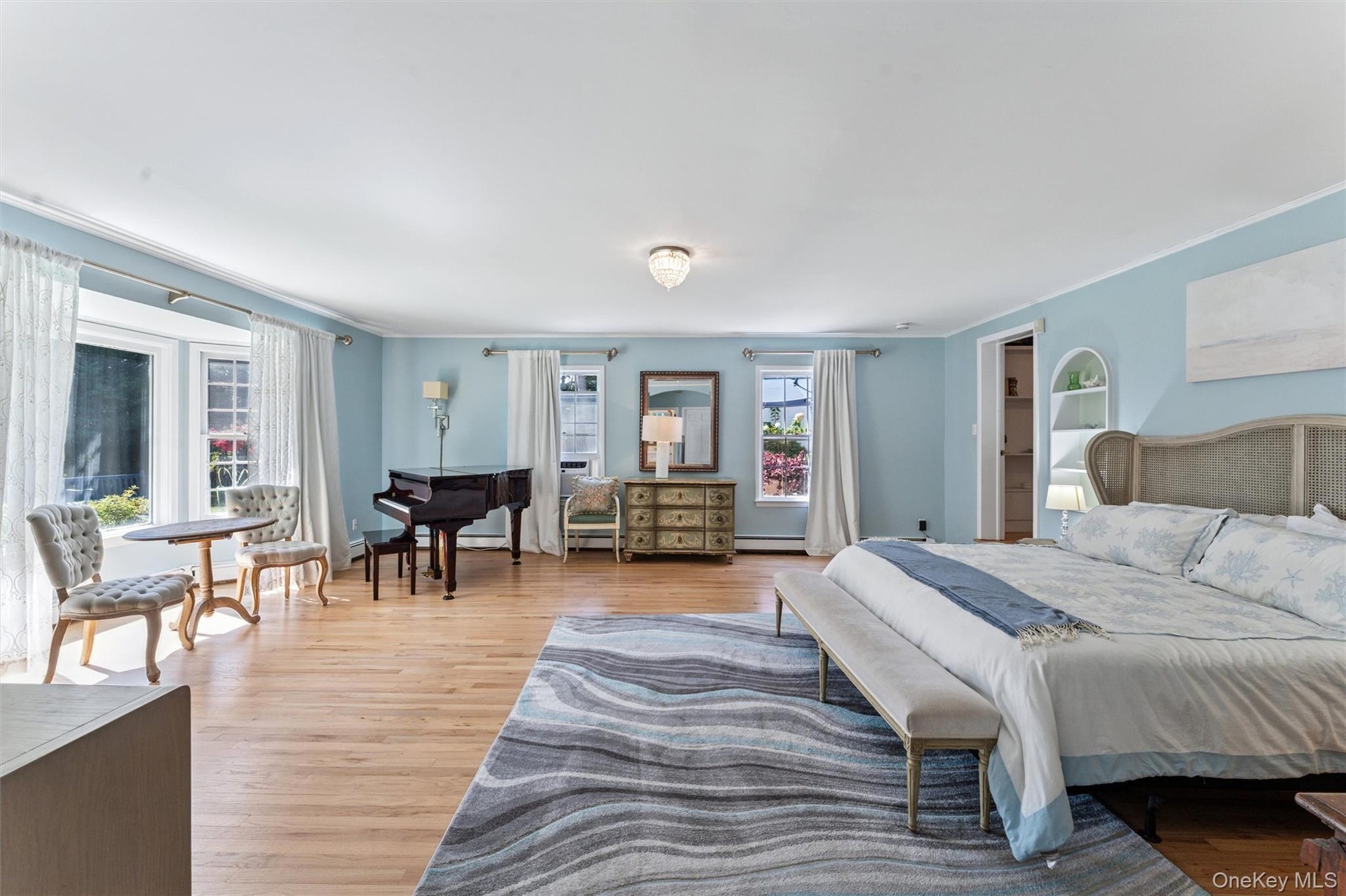 Bedroom with light wood-style flooring and crown molding