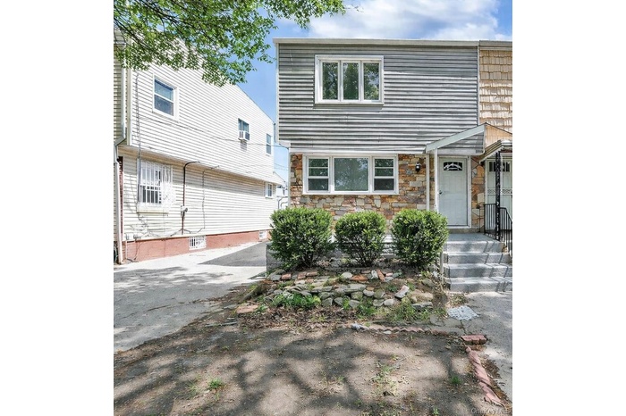 Colonial home with stone siding