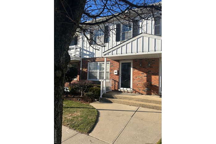 Property entrance featuring brick siding