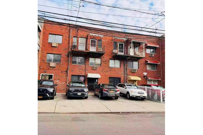 View of apartment building / complex featuring an AC wall unit