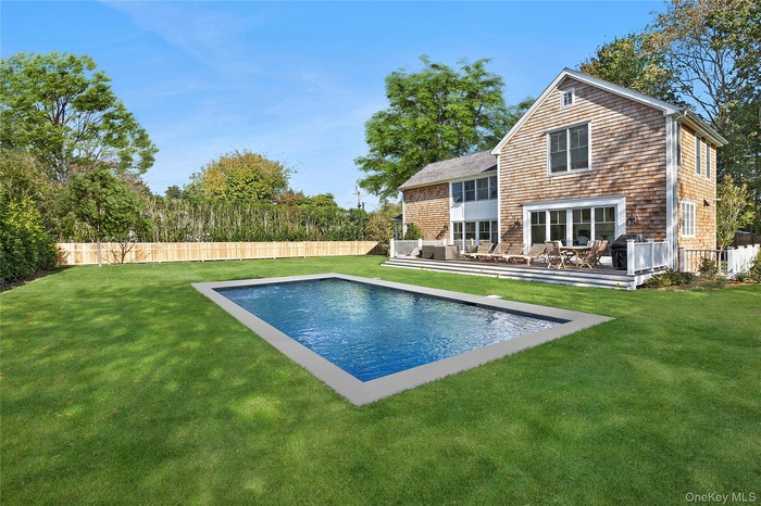 View of swimming pool featuring a fenced backyard, a patio area, a deck, and outdoor lounge area