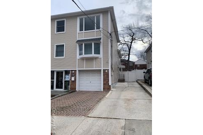 View of front of house featuring decorative driveway and a garage