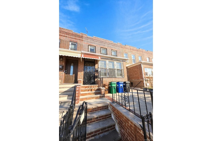 Rear view of house featuring brick siding