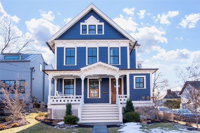 Victorian-style house featuring a porch and stairway