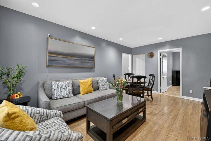 Living area with recessed lighting and light wood finished floors
