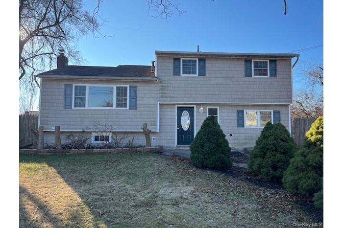 Tri-level home featuring a chimney