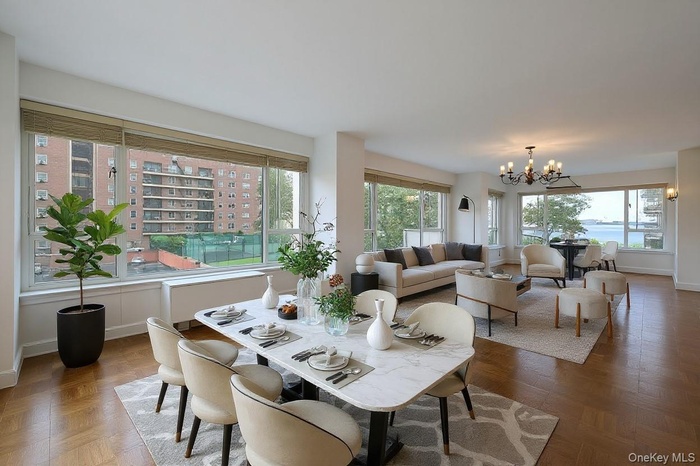 Dining room featuring a chandelier and baseboards