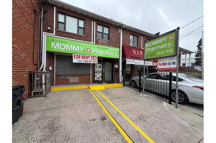 View of property featuring uncovered parking