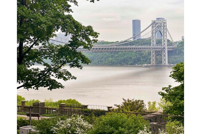 Water view with fence and a notable bridge