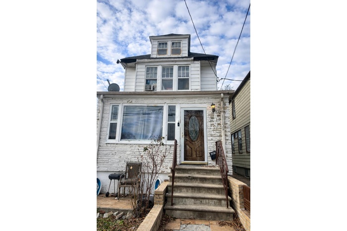 View of front facade featuring stone siding