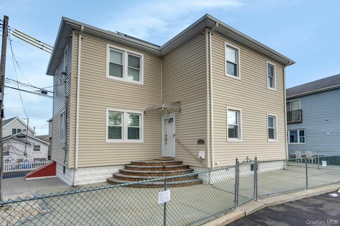 View of front of property featuring a gate and a fenced front yard