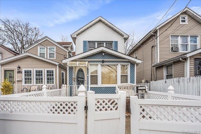 View of front of home with a gate and a fenced front yard