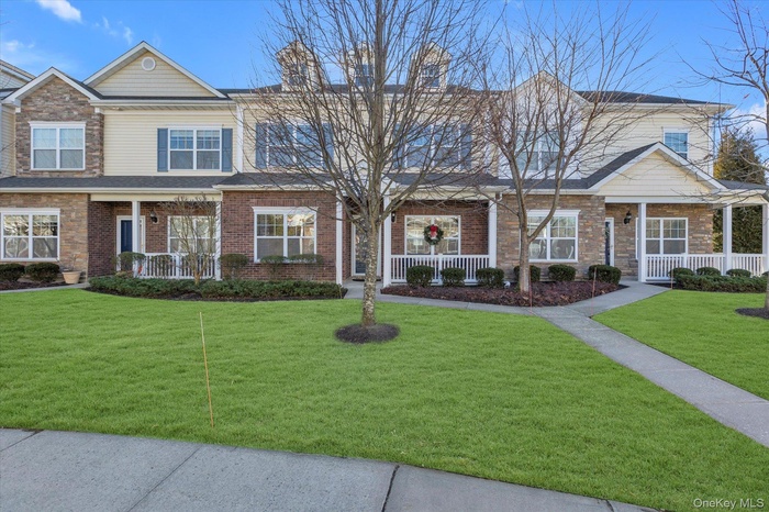 View of front of house featuring a porch and a front lawn