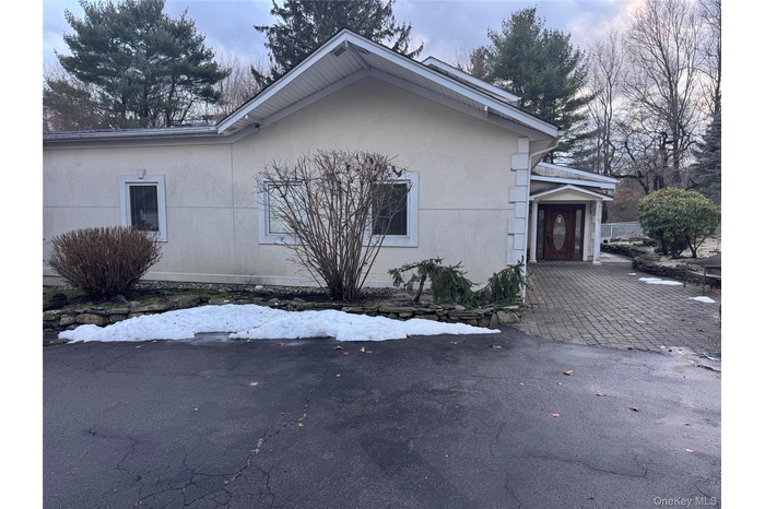 View of side of home with stucco siding