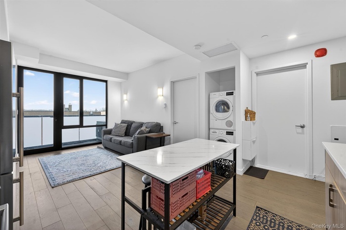 Kitchen with a water view, light wood-type flooring, freestanding refrigerator, and electric panel