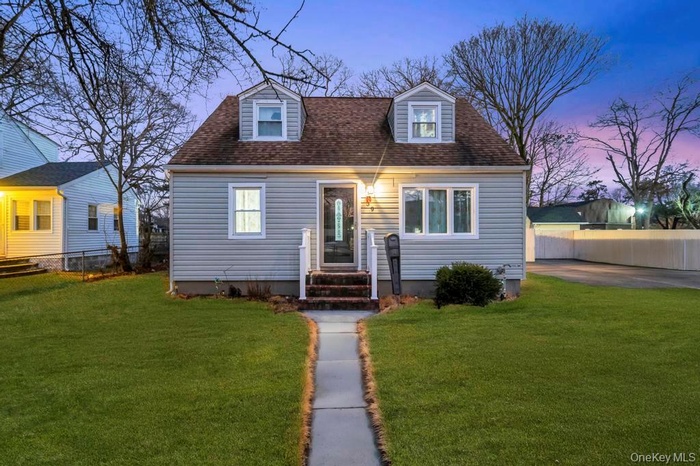 Cape cod home with a shingled roof
