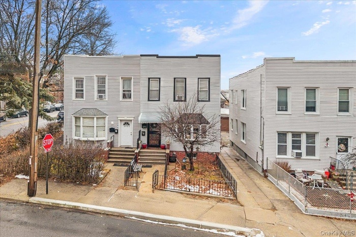 View of front of house with a fenced front yard and a gate