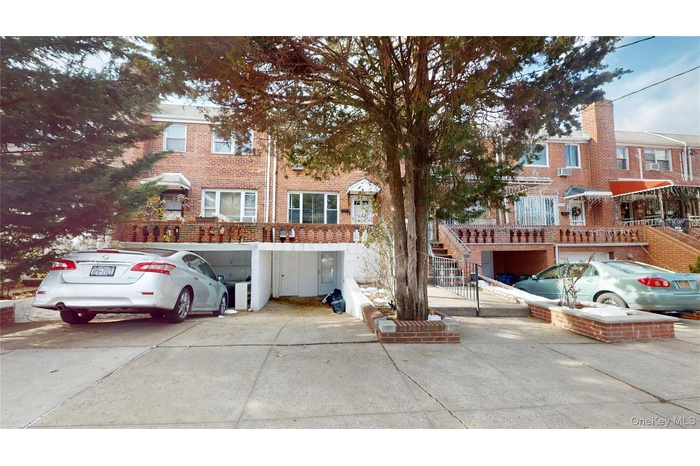View of front facade featuring stairway and brick siding