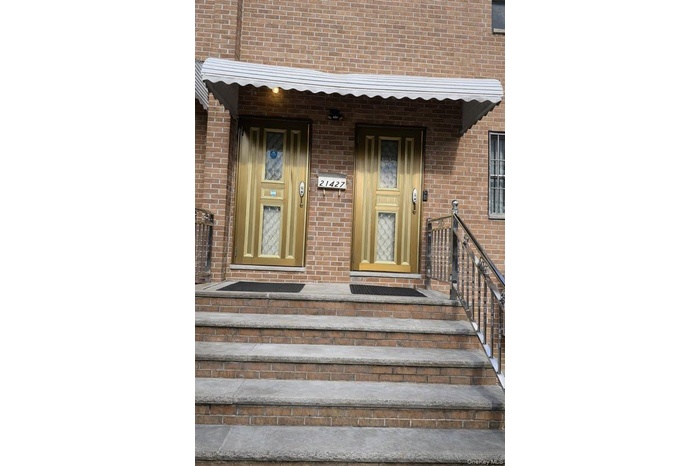 View of exterior entry with brick siding