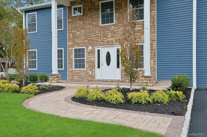 Entrance to property with stone siding and covered porch