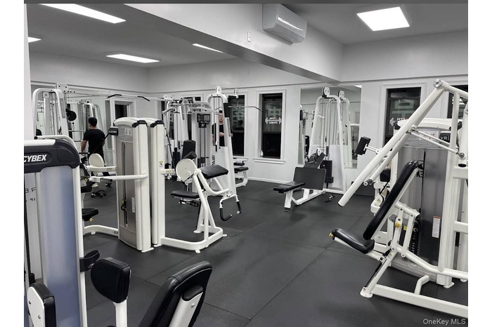 Workout area featuring a wall mounted AC