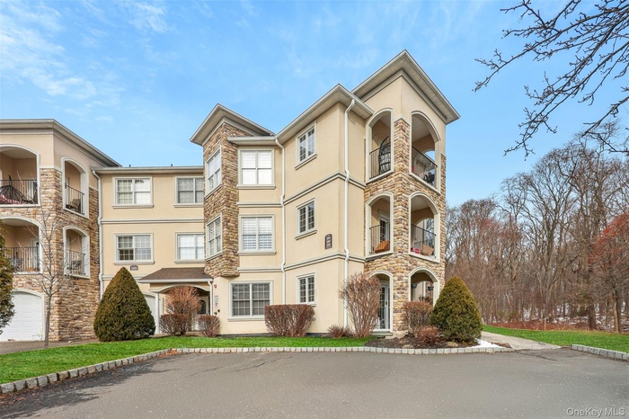 View of front of home with stucco siding and stone siding