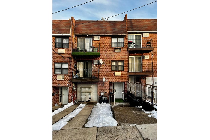 View of apartment building / complex with concrete driveway and an AC wall unit