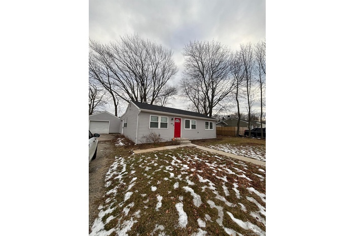Ranch-style house featuring an outbuilding and a garage