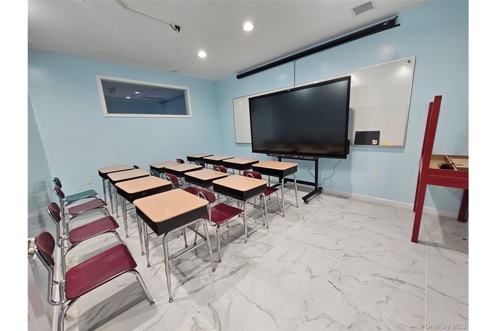 Dining area featuring light marble finish flooring and recessed lighting