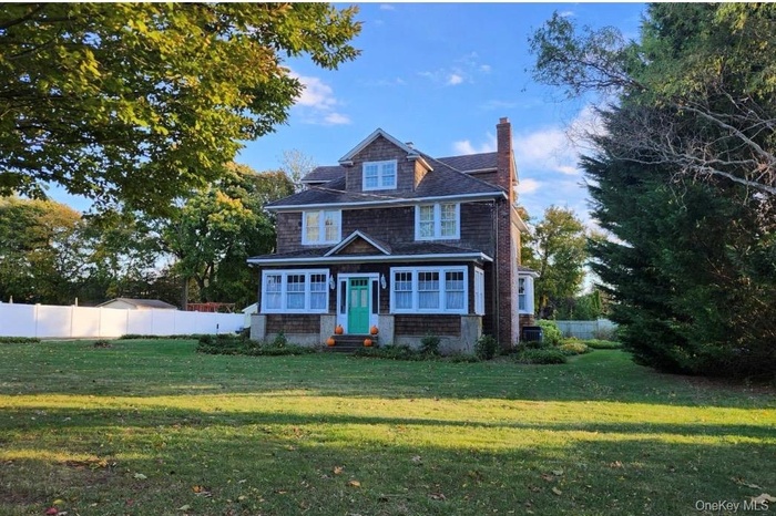 Shingle-style home with a chimney