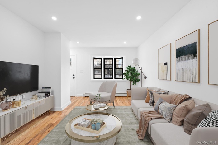 Living room featuring light wood-style floors and recessed lighting