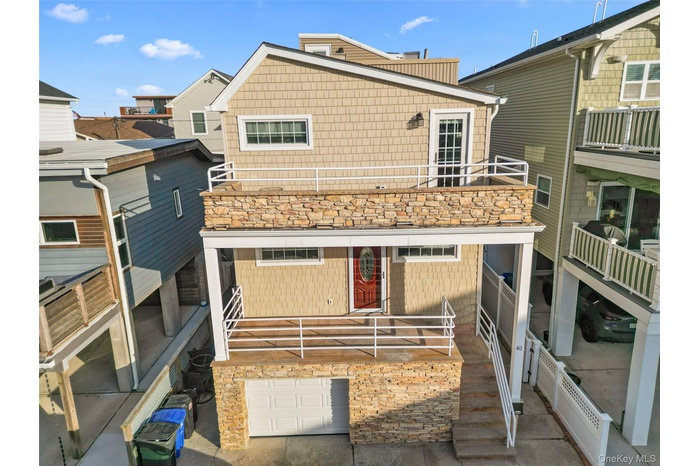 Back of house featuring a patio and a balcony
