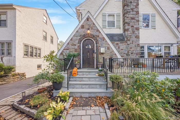Tudor-style house featuring stucco siding and stone siding