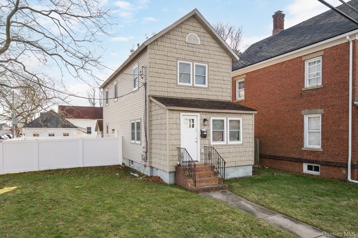 View of front of home featuring a chimney