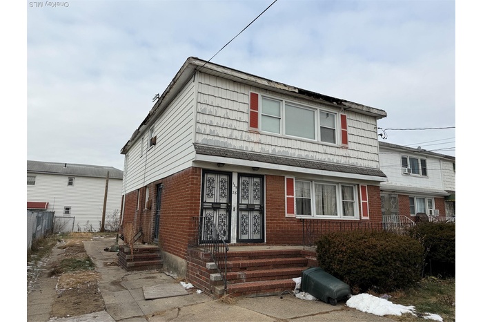 View of front facade featuring brick siding