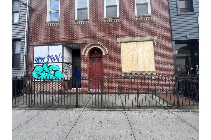 Entrance to property with brick siding and a gate