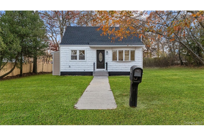View of front of home with a shingled roof