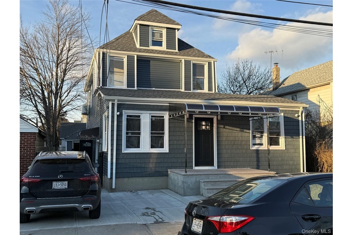 Traditional style home with roof with shingles