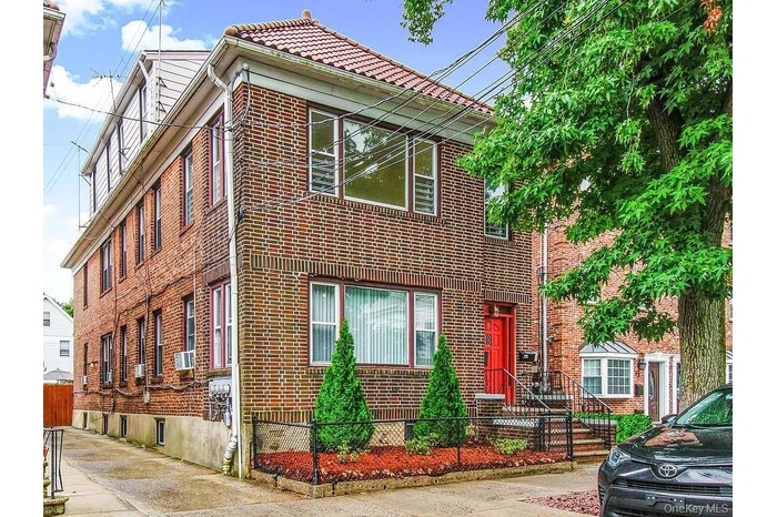 View of front facade with a fenced front yard and brick siding