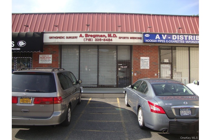 View of commercial location featuring uncovered parking