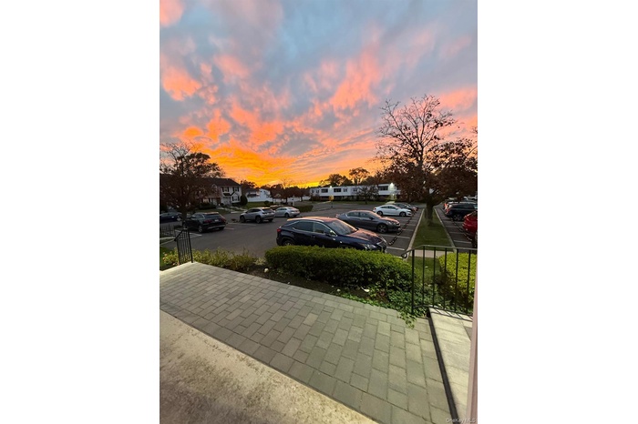 Parking at dusk featuring uncovered parking and a residential view