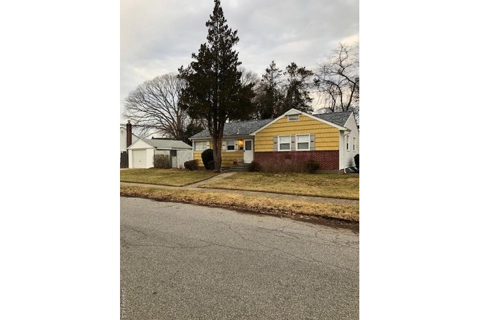 Ranch-style home featuring a front yard