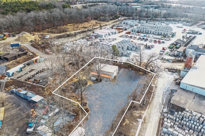 Aerial view of property and surrounding area with property boundaries highlighted and industrial structures